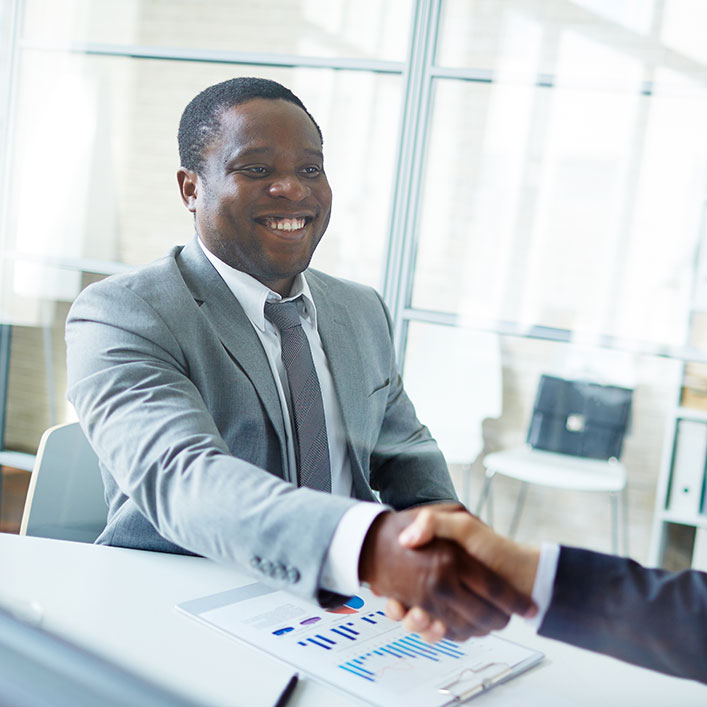 a smiling man shaking hand 